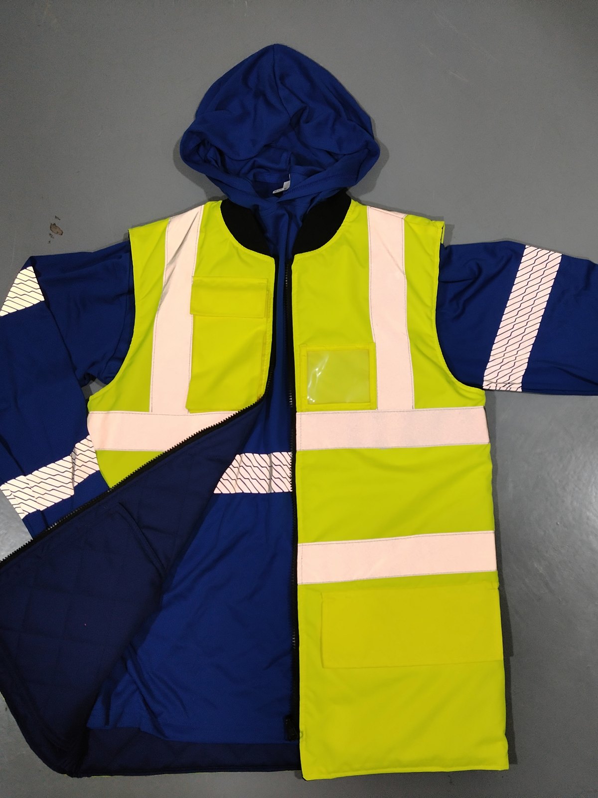 Hi-vis yellow parka over a royal-blue hooded inner layer: silver body bands, segmented sleeve film, quilted navy lining