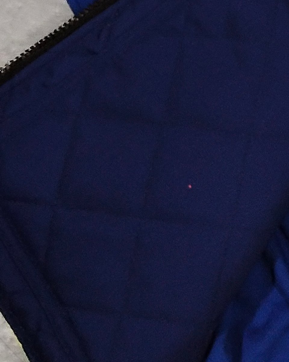 Quilted thermal lining close-up — navy diamond-stitch functional fabric